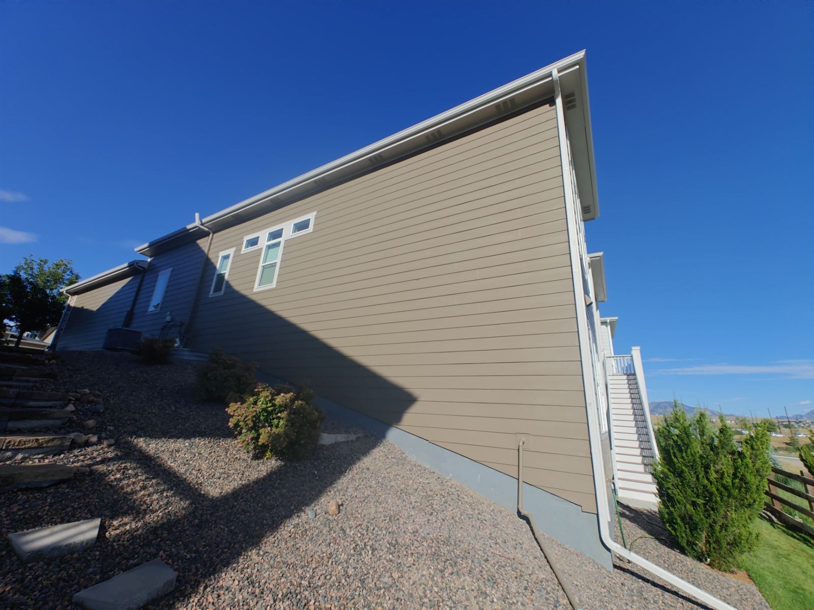 Completed exterior repaint of a home siding in Arvada, Colorado