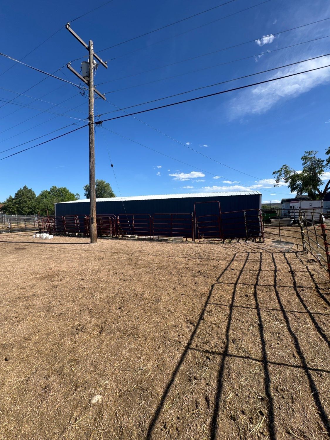 After: wide view of the finished blue shed and its metal roof on the Golden property