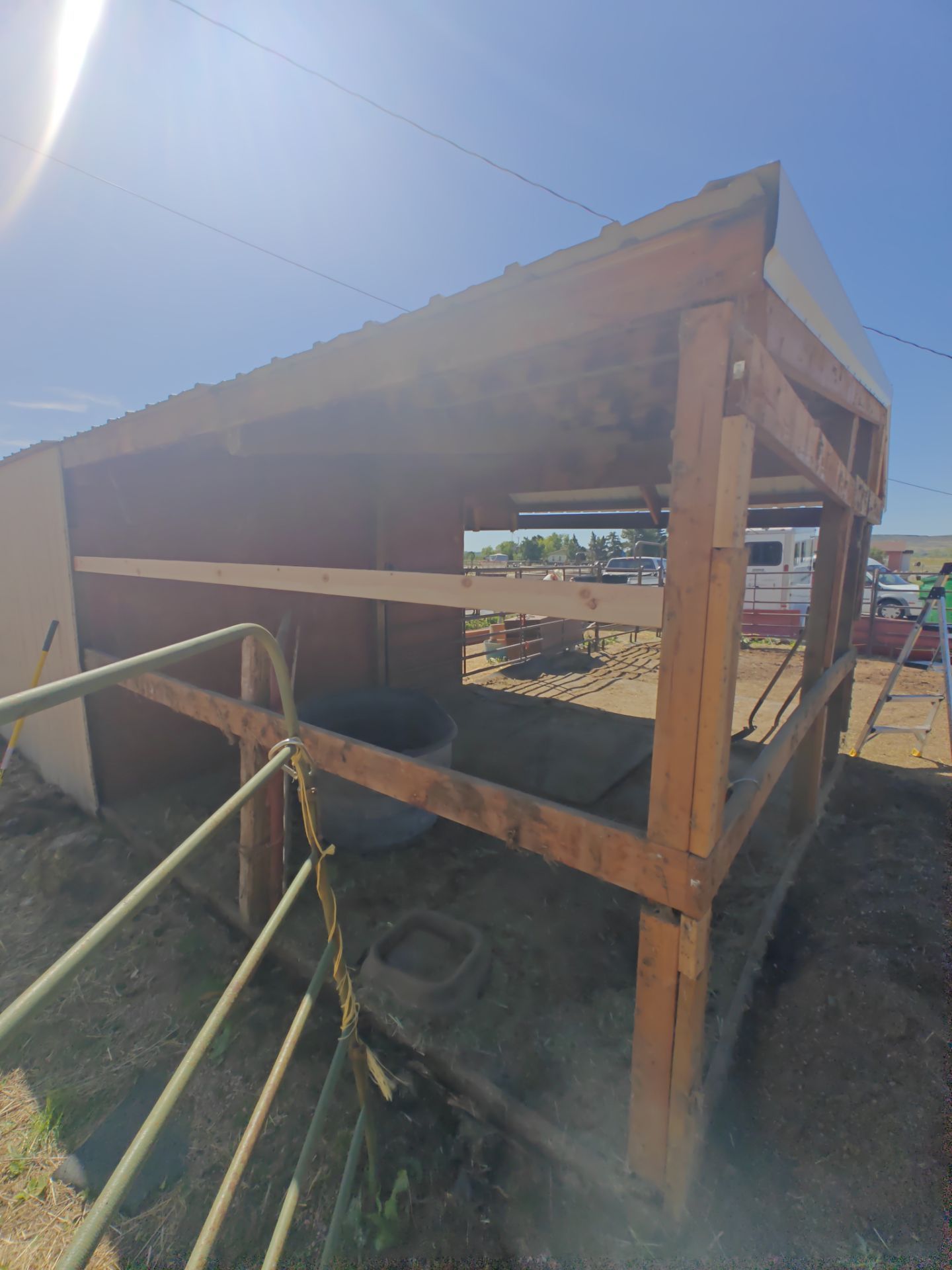 Shed framing exposed after the damaged metal siding was removed, with a new board added across the wall in Golden, Colorado